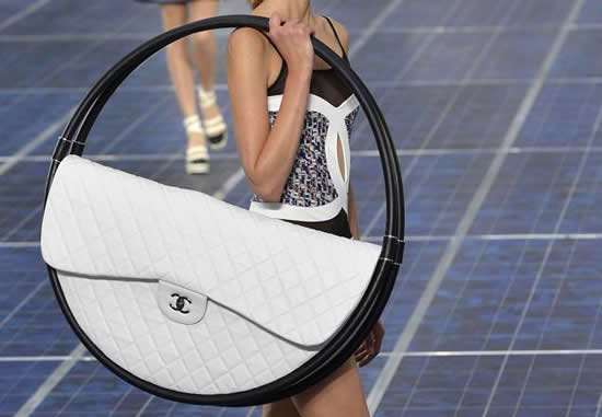 Giant Chanel bag balanced between hula-hoops at Paris Fashion Week
