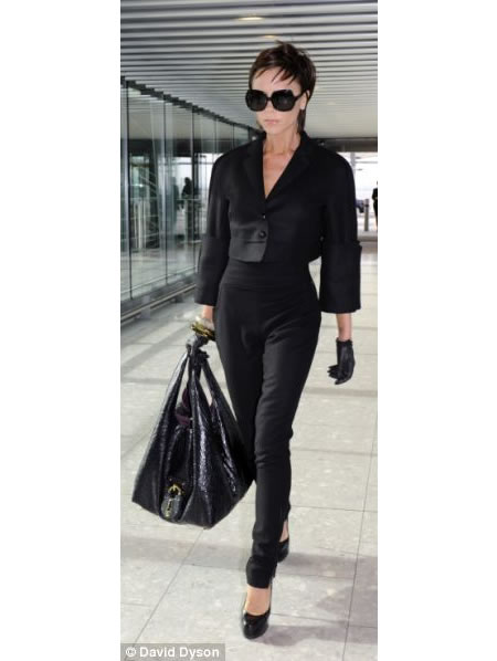 Why does Victoria Beckham never carry her handbags by the handle?