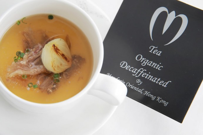 A full-bodied consommé with a specially prepared tea bag of dried flower petals and gold flake
