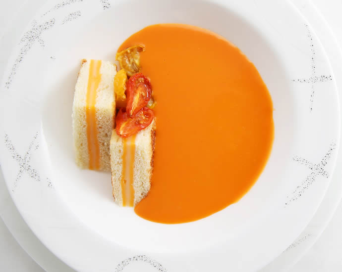 A soup of slow-roasted tomatoes with miniature grilled cheese sandwiches