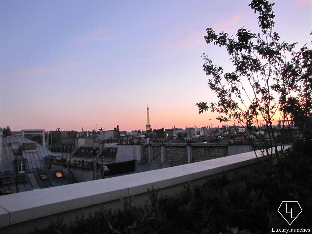 We step on to the wraparound balcony to watch the Eiffel Tower at sunset.