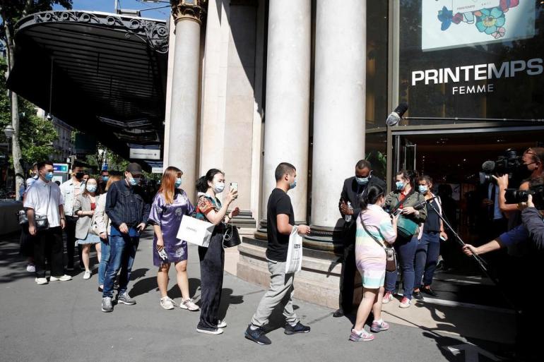 Shoppers line up outside luxury boutiques as Printemps department store ...